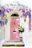 The scene captures the delicate thrill of a new chapter beginning in Belsize Park, as if you are walking up to your new front door for the very first time. A pale pink door glows softly in the afternoon light, its smooth surface set against whitewashed walls that brighten the narrow entryway. A matching blush shutter sits to one side, slightly ajar, suggesting a quiet, lived-in charm. Above, cascades of lavender wisteria drape down in gentle curtains, their clusters of blossoms hanging in graceful arcs that whisper of early summer along the tree-lined streets near Belsize Park Underground. The wisteria forms a natural canopy, filtering the sunlight into speckled patterns that fall across the steps and door. At the doorstep itself rests a stylish tin bucket overflowing with creamy white roses, their petals lush and velvety, almost tumbling over the rim in their abundance. Fresh green foliage is tucked between the rose heads, adding movement and contrast, while a soft pink ribbon tied around the bucket offers a final, romantic touch. The combination of pastel pinks, whites, and gentle greens creates a calm, pastel-toned harmony that feels both optimistic and soothing, ideal for marking a housewarming or sending congratulations on your new home wishes. Crafted with the care you'd expect from a local florist who knows the neighbourhood's love of understated elegance, the arrangement seems to radiate quiet joy, as if every petal is blessing the threshold with warmth, welcome, and the promise of many happy years to come.